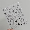 Clear sheet of 5D bronzing gothic nail art stickers featuring various symbols and designs