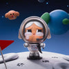 A collectible figurine of a crying astronaut with a helmet on a white moon surface under a starry sky.