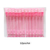 A clear plastic package containing twelve pink mini bubble wands for party favors and celebrations