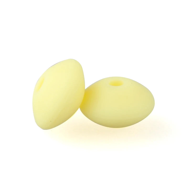 Two yellow silicone lentil beads shaped like an abacus for jewelry making
