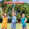 Three children playing with giant bubble wands outdoors in a grassy park setting.
