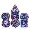 A set of seven frosted crack resin polyhedral dice in various colors and shapes.