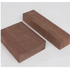 A rectangular board of dark brown black walnut wood, cut with clean edges, shown at an angle.