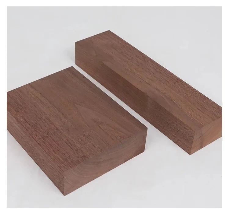 A rectangular board of dark brown black walnut wood, cut with clean edges, shown at an angle.