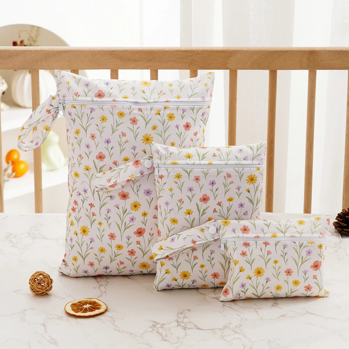 A set of three floral patterned waterproof bags for swimsuits, diapers, and travel items
