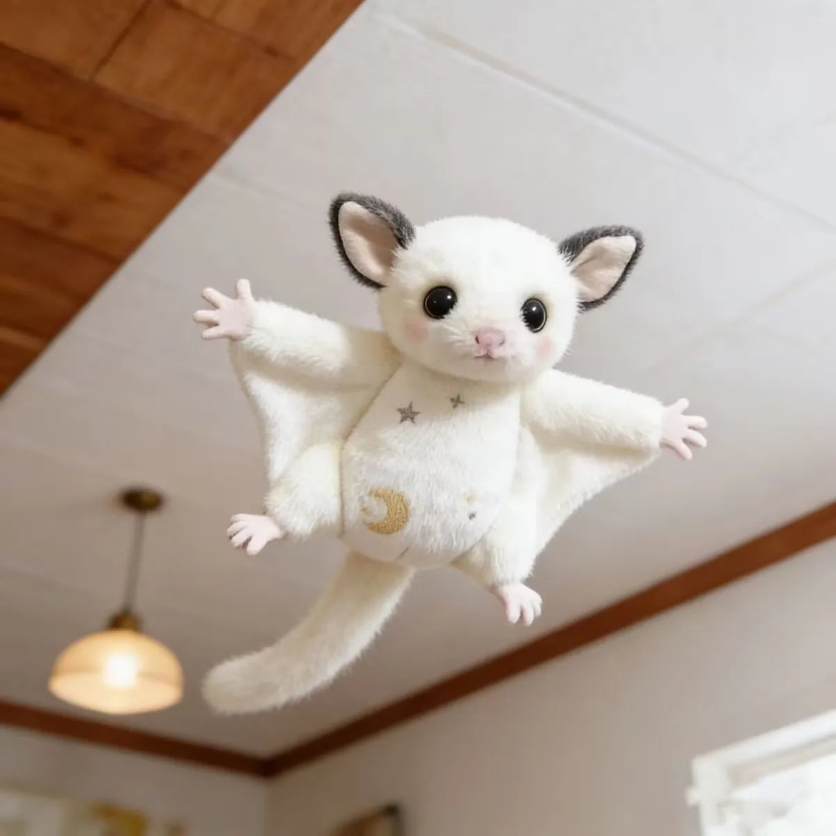 A white plush mouse with large ears is shown flying against a light ceiling.