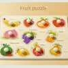 A wooden fruit puzzle board featuring various cut-out fruits like banana, strawberry, orange, apple, watermelon, and others f