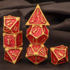 A set of seven polyhedral metal dice in red and gold on a dark background.
