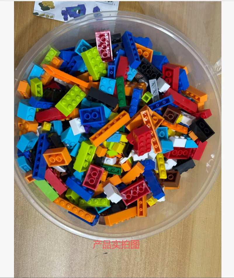 A clear plastic container filled with assorted colorful building blocks for a creative STEM toy set