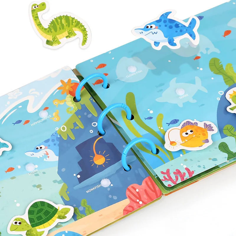 A Montessori busy book for toddlers featuring colorful plastic sea creatures and animals on a page.