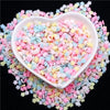 A heart-shaped bowl filled with colorful polymer clay sprinkles for slime and craft decor