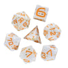 A set of seven white and orange polyhedral dice, resembling cheese, are displayed against a white background.