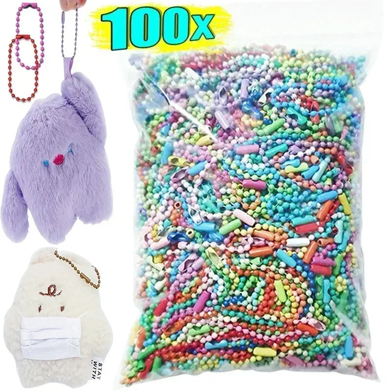 A clear bag filled with colorful ball bead chains for DIY jewelry and keychains, shown next to a fluffy purple plush toy.