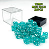 A pile of 12mm mini dice in various shades of teal and green scattered next to a clear display box.