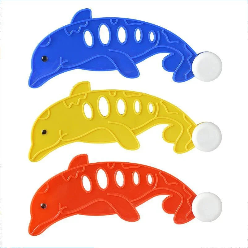 Three plastic shark-shaped pool diving toys in blue, yellow, and orange.