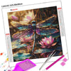 A diamond painting kit featuring a dragonfly design on canvas with various colored beads and tools.