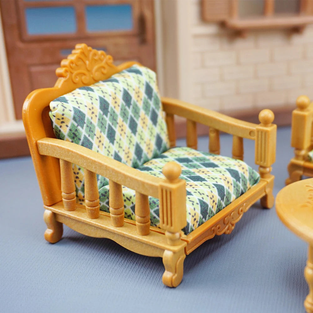 A wooden dollhouse furniture playset featuring a miniature armchair with a yellow frame and patterned fabric.