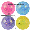 Three colorful spheres of varying colors including pink blue and yellow showing different light effects