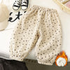 Light beige fleece-lined pants with a small floral print laid out on a white surface.
