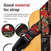 A close-up of a vintage floral guitar strap with picks and locks shown next to an acoustic guitar body.