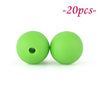 Two bright lime green silicone beads are shown against a white background.