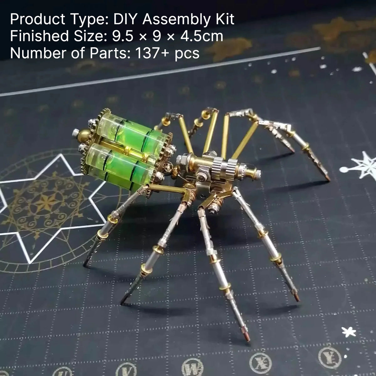 A finished steampunk metal spider assembly kit with green and brass parts displayed on a dark surface.