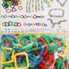 A collection of colorful, interlocking plastic rings and chains used for building mosaic toys.