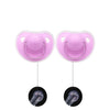 A pair of pink silicone pacifiers with protective covers and silicone soothers for baby comfort