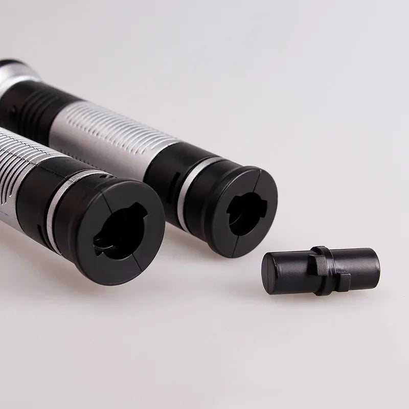 A set of black and silver laser lightsaber toy components, including a handle and blade sections.