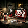 A horror movie puppet model building set featuring a white mask and red accents, displayed in a dark, gritty setting.