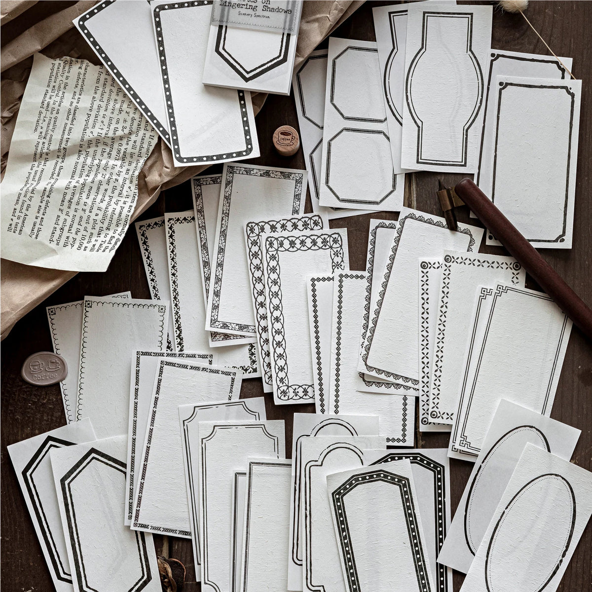 A collection of vintage scrapbooking paper sheets in white and gray patterns for journaling and crafts.