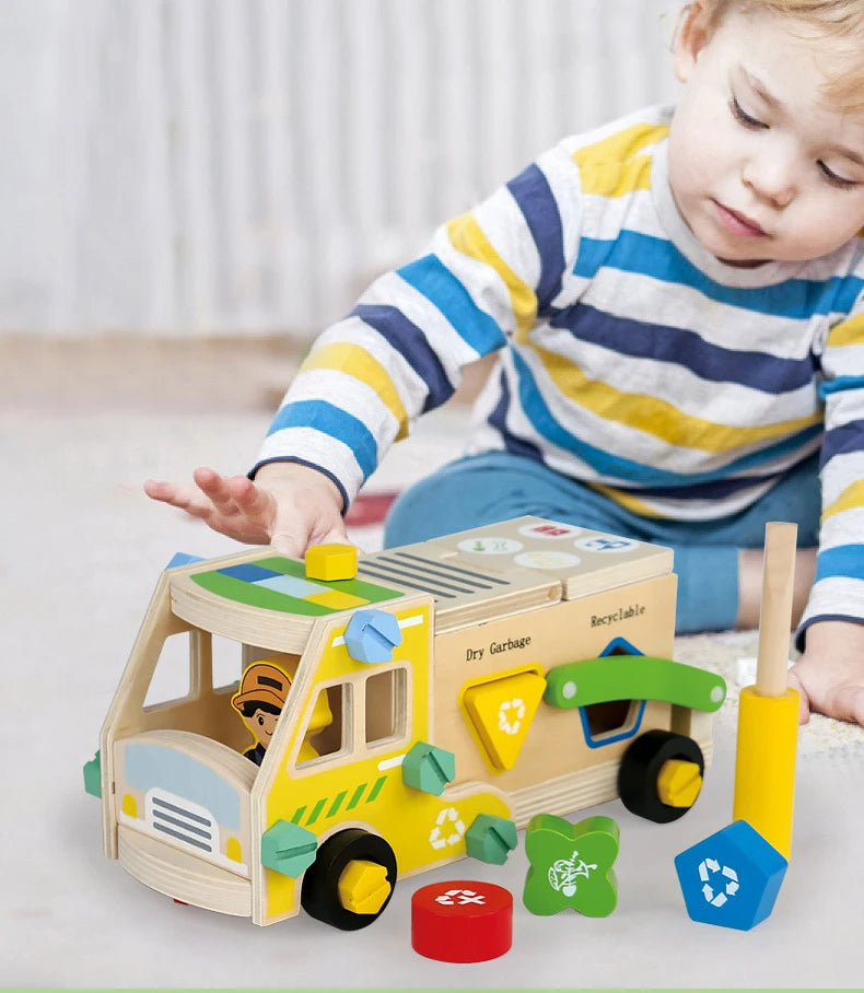 A young child is playing with a wooden toy vehicle set that includes tools and building pieces.