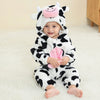 A baby wearing an adorable animal hooded romper with a white and black cow print face mask