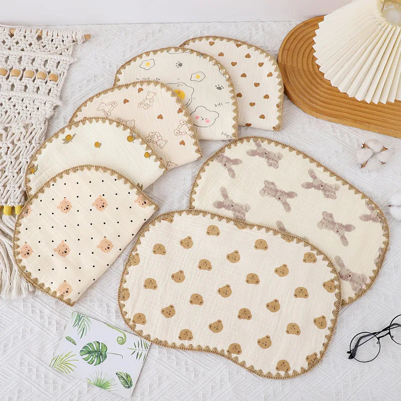 A collection of light beige and cream 10-layer cotton gauze flat pillows for newborns, including a round pillow and a rectang