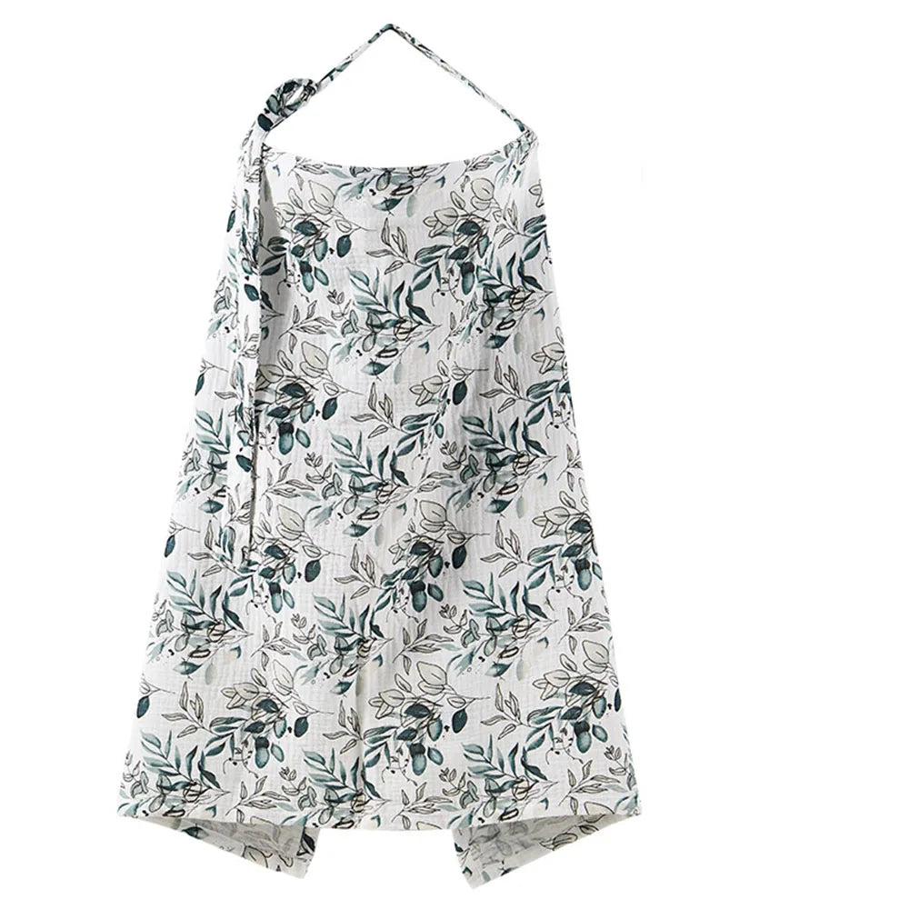 A white and blue botanical print muslin nursing cover with an adjustable neckline.
