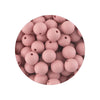 A circular arrangement of pink silicone beads in various sizes for DIY jewelry making