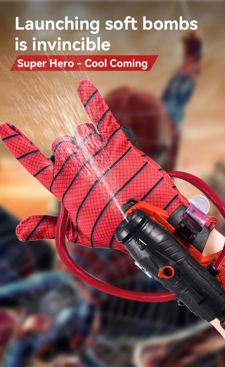 A hand wearing a red patterned glove is launching a stream of water from an orange wrist launcher.