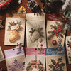 A collection of embossed Christmas advent cards and decorative paper sheets featuring winter themes and festive designs.