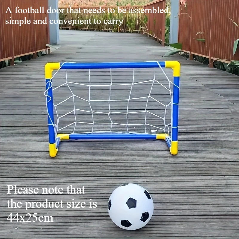 A yellow and blue portable soccer goal frame with a white ball is placed on a wooden deck.