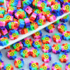 A collection of colorful polymer clay smiling sunflower beads for jewelry making