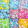 A collection of colorful plastic balls in various shades including blue, pink, yellow, and white.