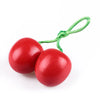 A set of red wooden fruit and vegetable cutting toys with green string handles.