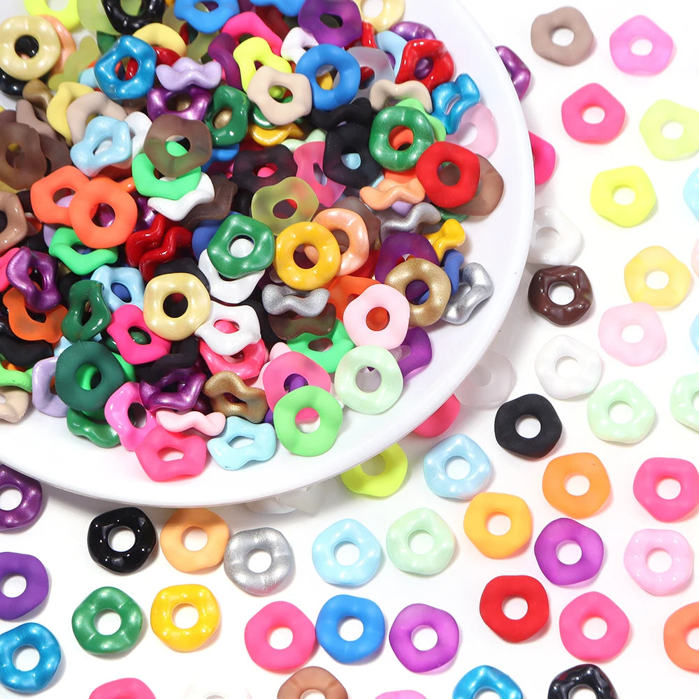 Assortment of colorful acrylic spacer beads in various shapes and colors