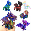 A collection of five articulated 3D printed dragon figurines in various colors and finishes.