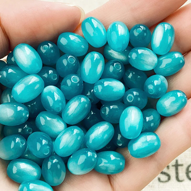 A handful of bright turquoise blue resin starry sky cat's eye beads for jewelry making