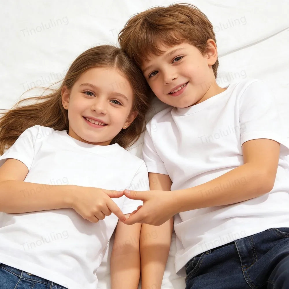 A young boy and girl smiling while wearing white t-shirts