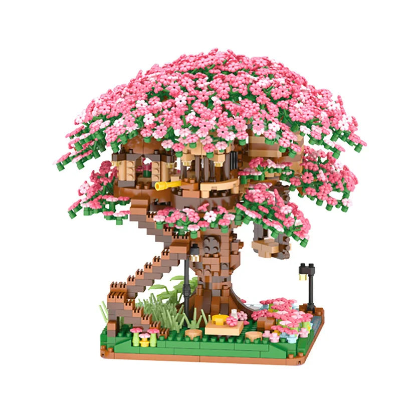 A miniature tree structure built from building blocks covered in pink blossoms and featuring a light.