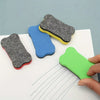Three magnetic dry erase erasers in gray, blue, and green are shown on a white surface.