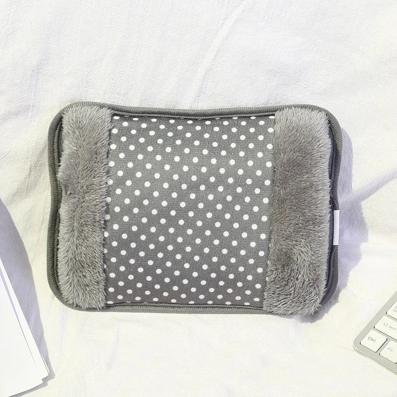 A gray rechargeable hot water bottle with a fluffy gray cover and white polka dots on the fabric.