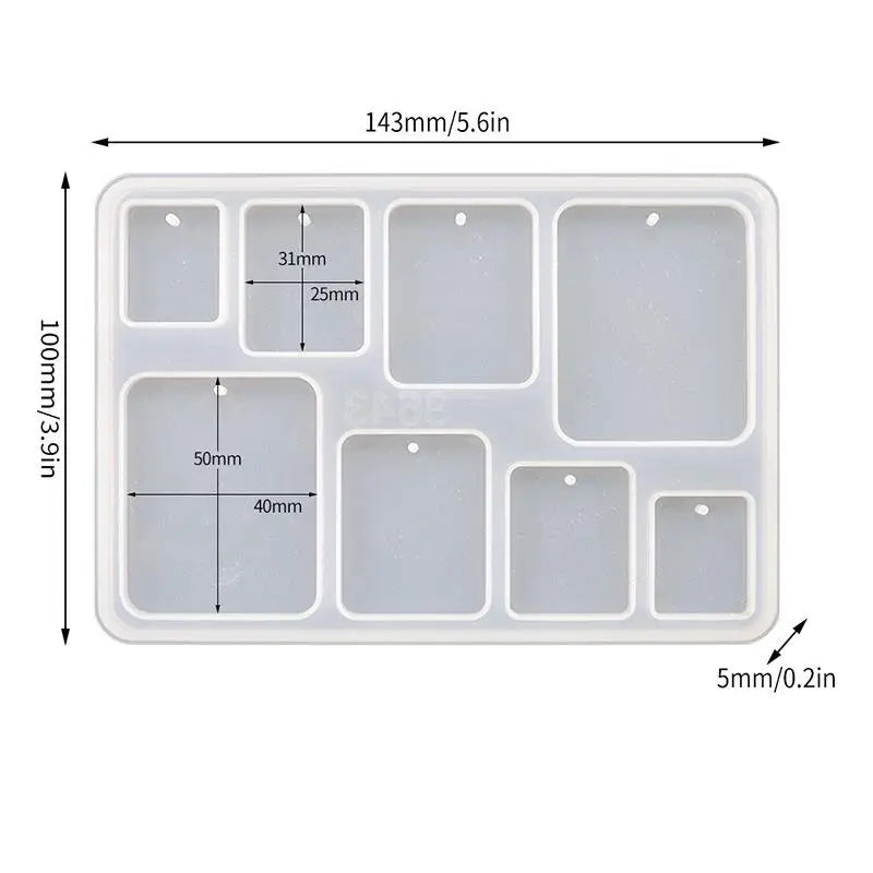 A white silicone mold set with six square and rectangular cavities for making epoxy resin jewelry.
